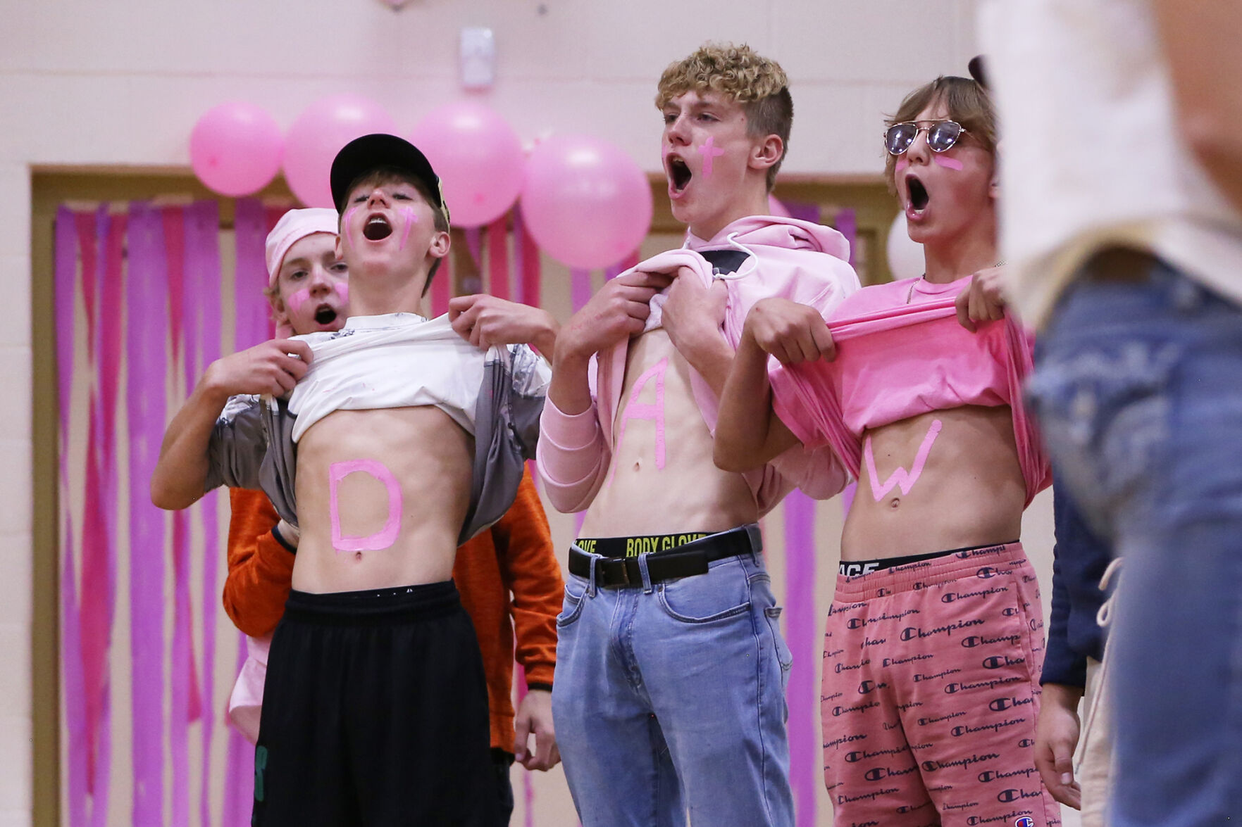 Jeron Sutton, Brady Engling and Marshall Peters lift their shirt and scream "DAWG!"